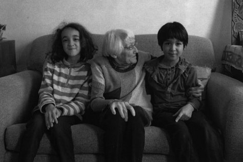 Maxi sitting on a sofa with grandchildren