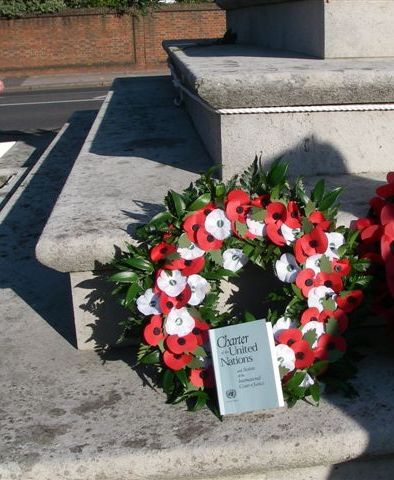 Wreath on steps of Memorial with UN Charter