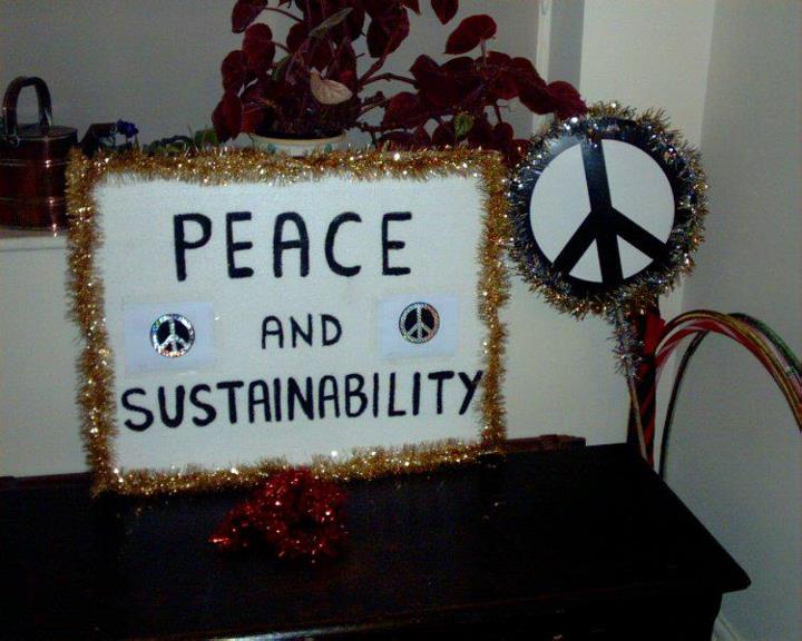 Placard and CND sign on a stick with tinsel